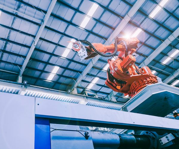 technology and industry 4.0 revolution  concept from high precision robotic system control set up at top of injection machine